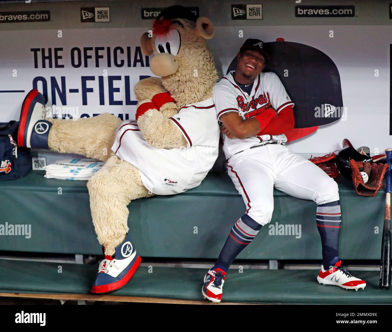 Atlanta Braves left fielder Ronald Acuna Jr. (13) and Braves mascots Blooper  have fun in the dugout before am baseball game against the Miami Marlins  Tuesday, July 31, 2018 in Atlanta. (AP