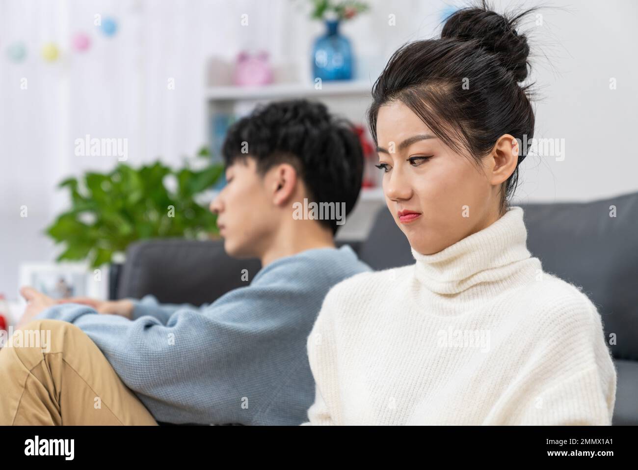 Young lovers quarrel on the sofa in the sitting room Stock Photo - Alamy