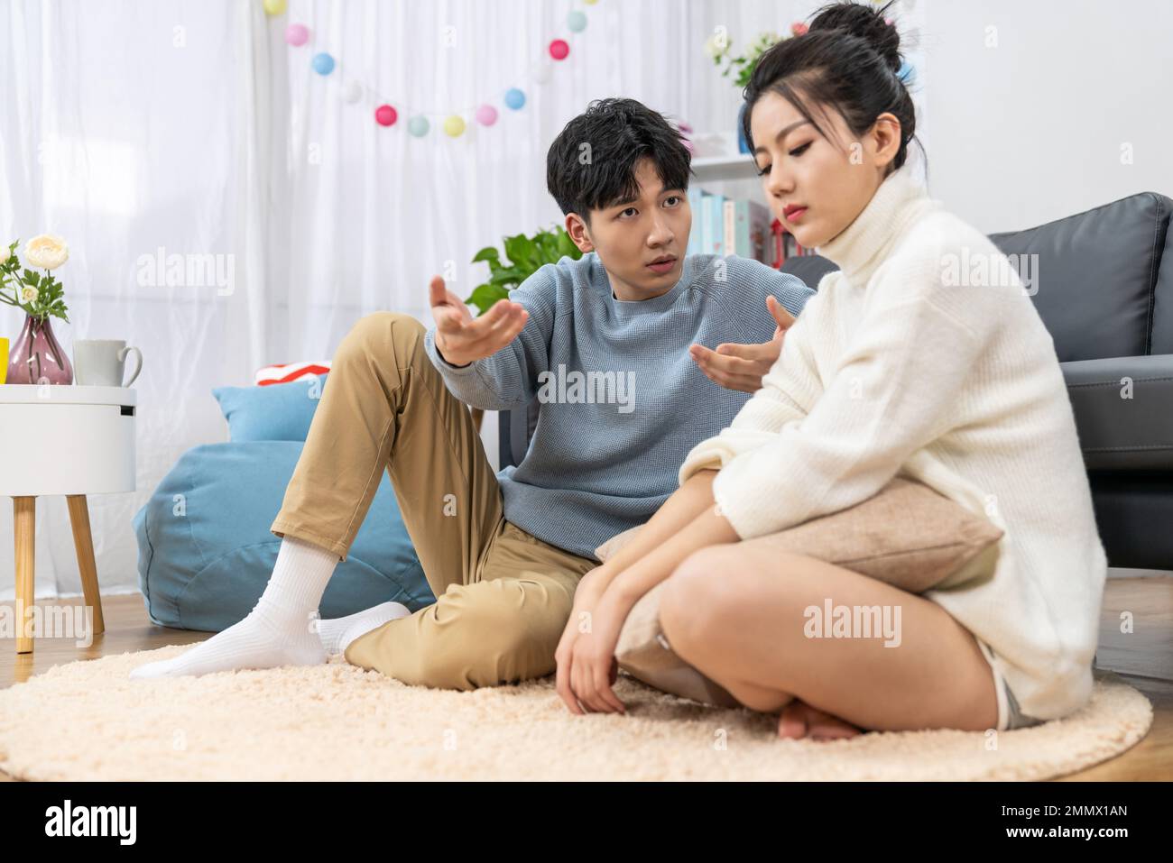 Young lovers quarrel on the sofa in the sitting room Stock Photo - Alamy