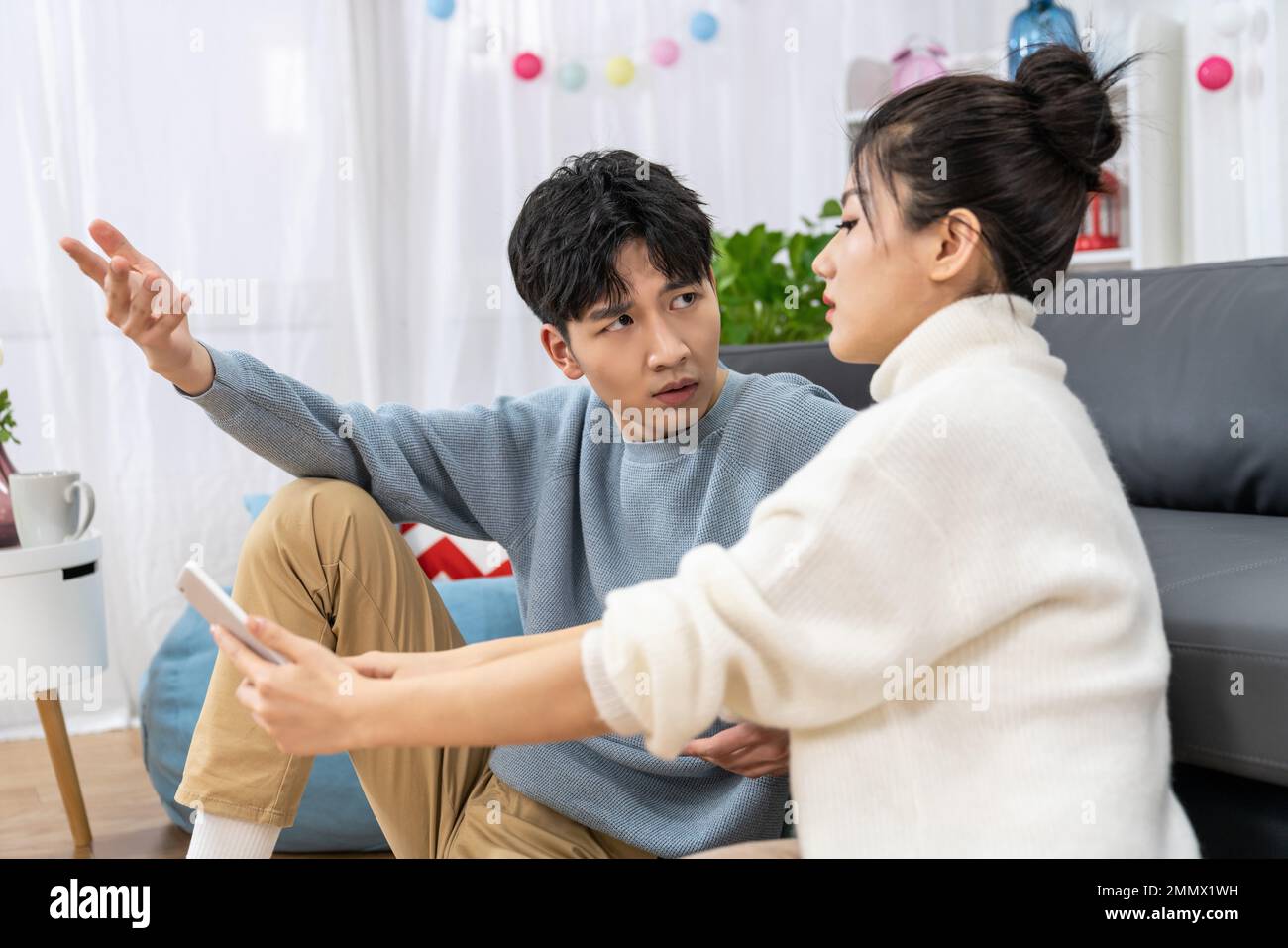 Young lovers quarrel on the sofa in the sitting room Stock Photo - Alamy