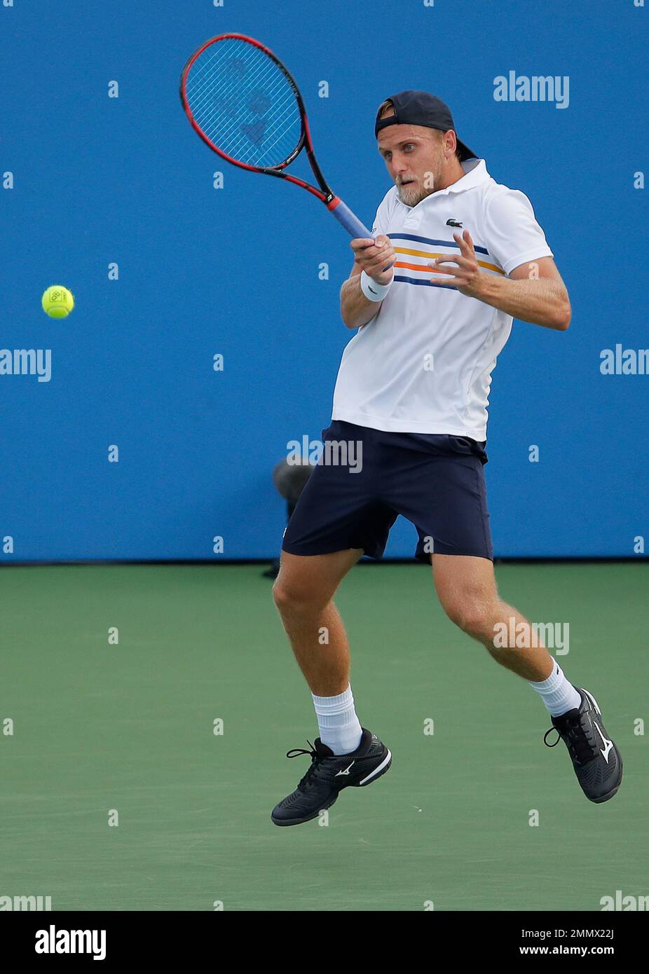 Denis Kudla, of the United States, returns a shot to Dusan Lajovic, of Serbia, during the second round of the US Open tennis championships Thursday, Aug