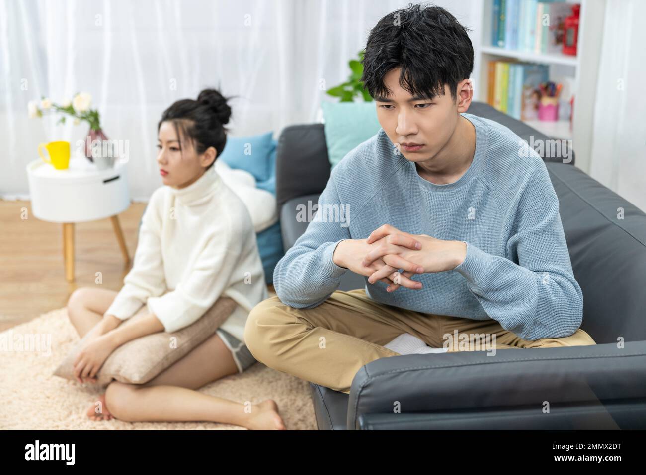 Young lovers quarrel on the sofa in the sitting room Stock Photo - Alamy