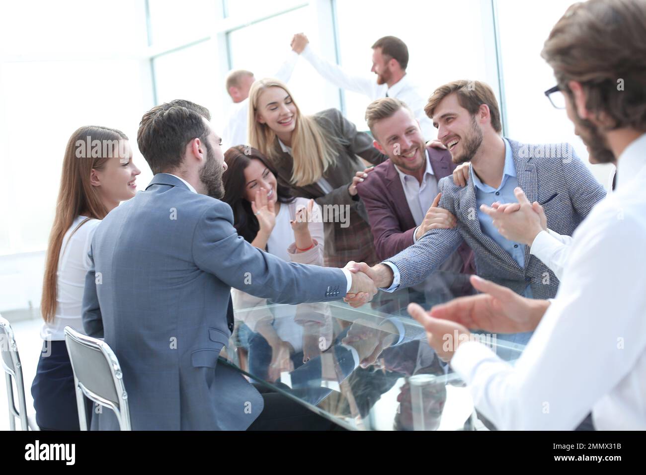 business people shaking hands sitting at the office Desk. concept of ...