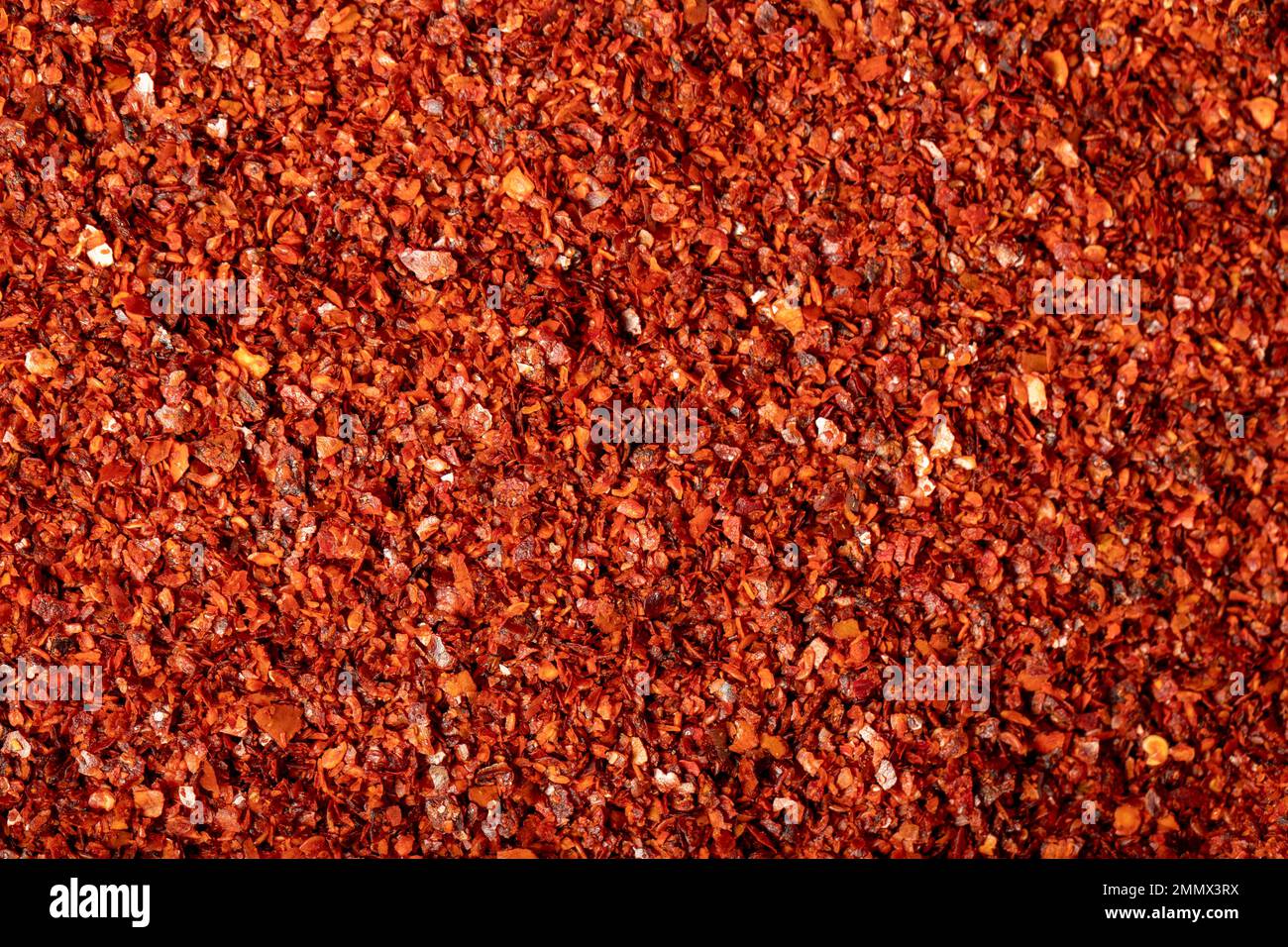 Red pepper flakes. Heap of crushed peppers. Top view of dried chili