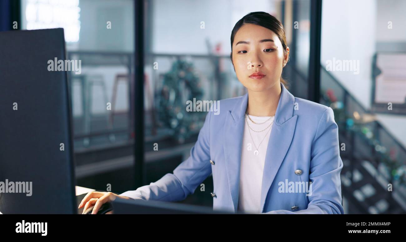 Watch, deadline and computer with a business asian woman working late at night in her office for overtime. Finance, accounting and dedication with a Stock Photo
