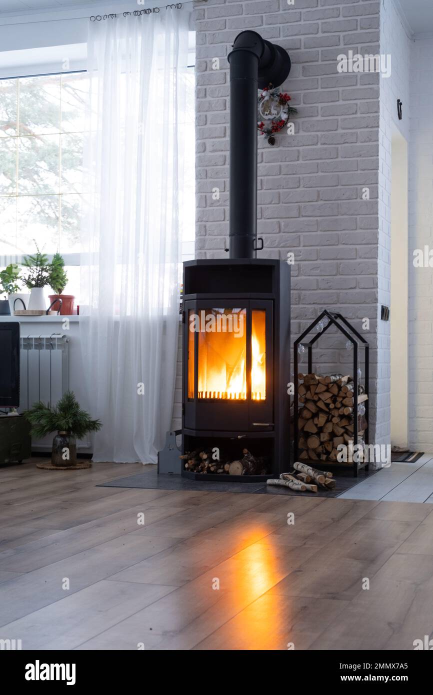 Black stove, fireplace in interior of house in loft style. Alternative