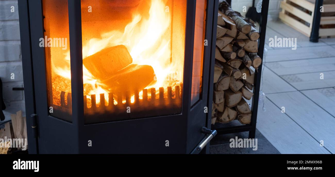 Fuel briquettes made of pressed sawdust for kindling the furnace -  economical alternative eco-friendly fuel for the fireplace in the house.  Firewood i Stock Photo - Alamy