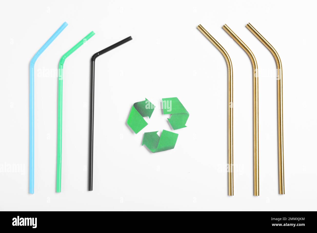 Recycling symbol, plastic and metal drinking straws on white background