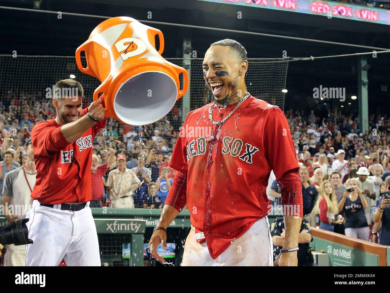 Boston Red Sox's Mookie Betts laughs after being doused with
