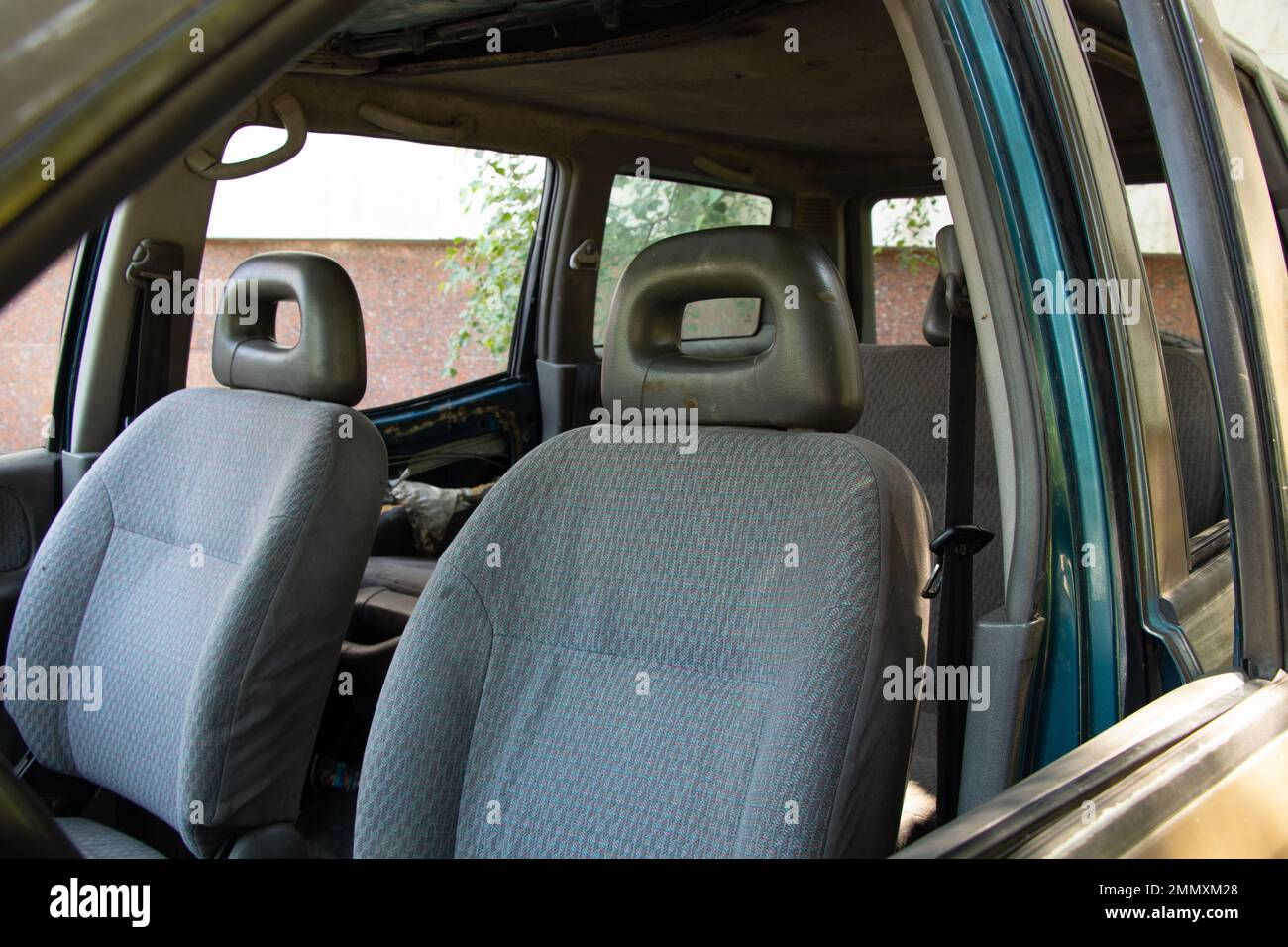 old broken car stands in the sun, car in a junkyard Stock Photo
