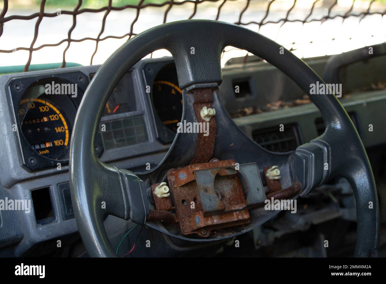 old broken military vehicle with bars on the front window, the car after the passage of hostilities, auto Stock Photo
