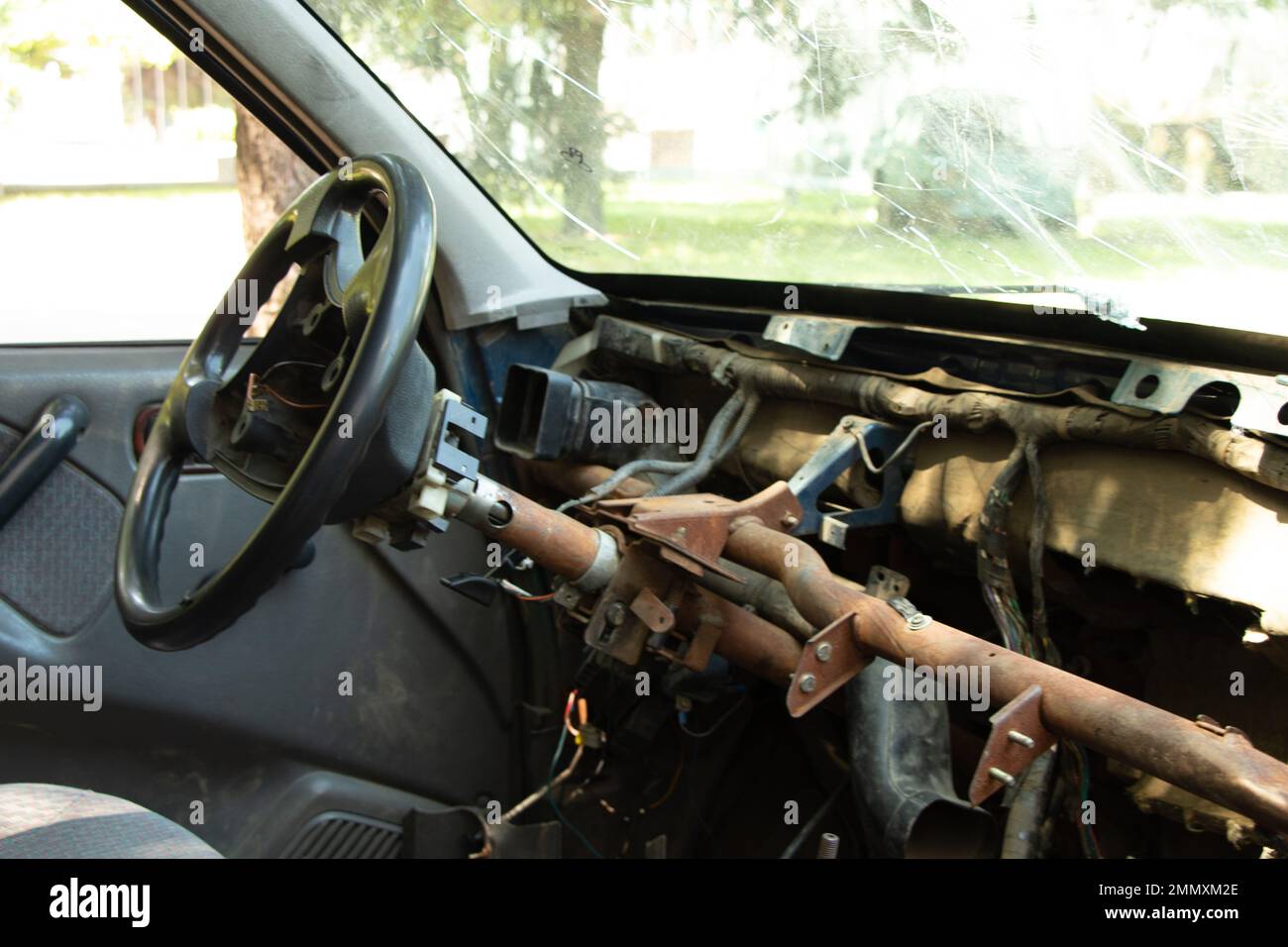 old broken car stands in the sun, car in a junkyard Stock Photo