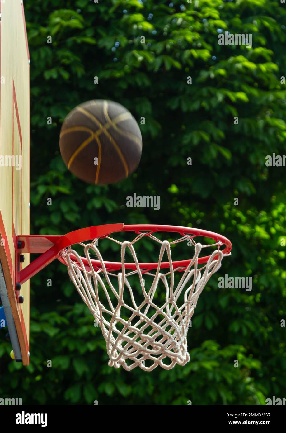 A basketball in the net. The fly ball is in the ring. A sports game