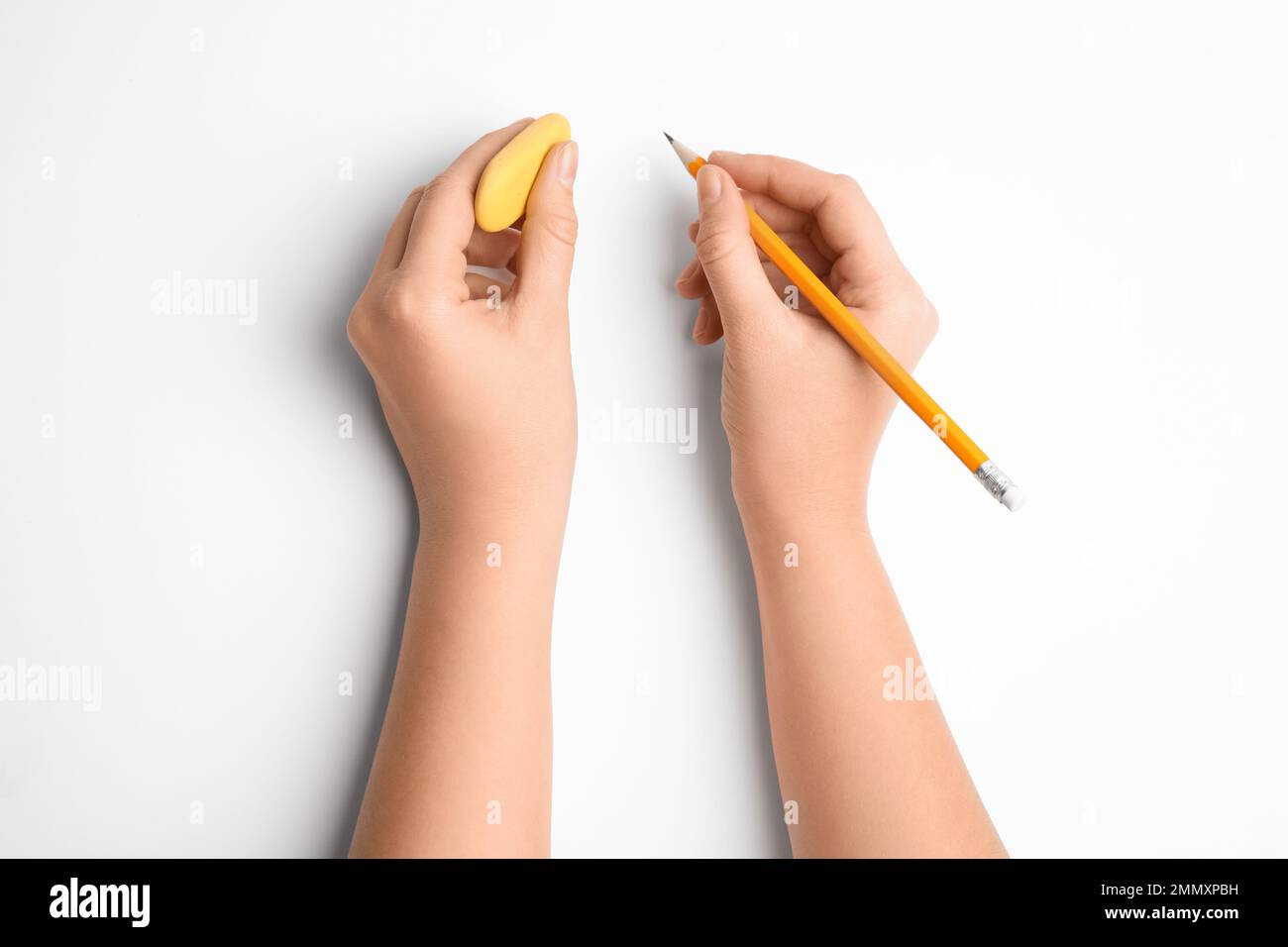 Woman holding pencil and eraser on white background, top view Stock ...