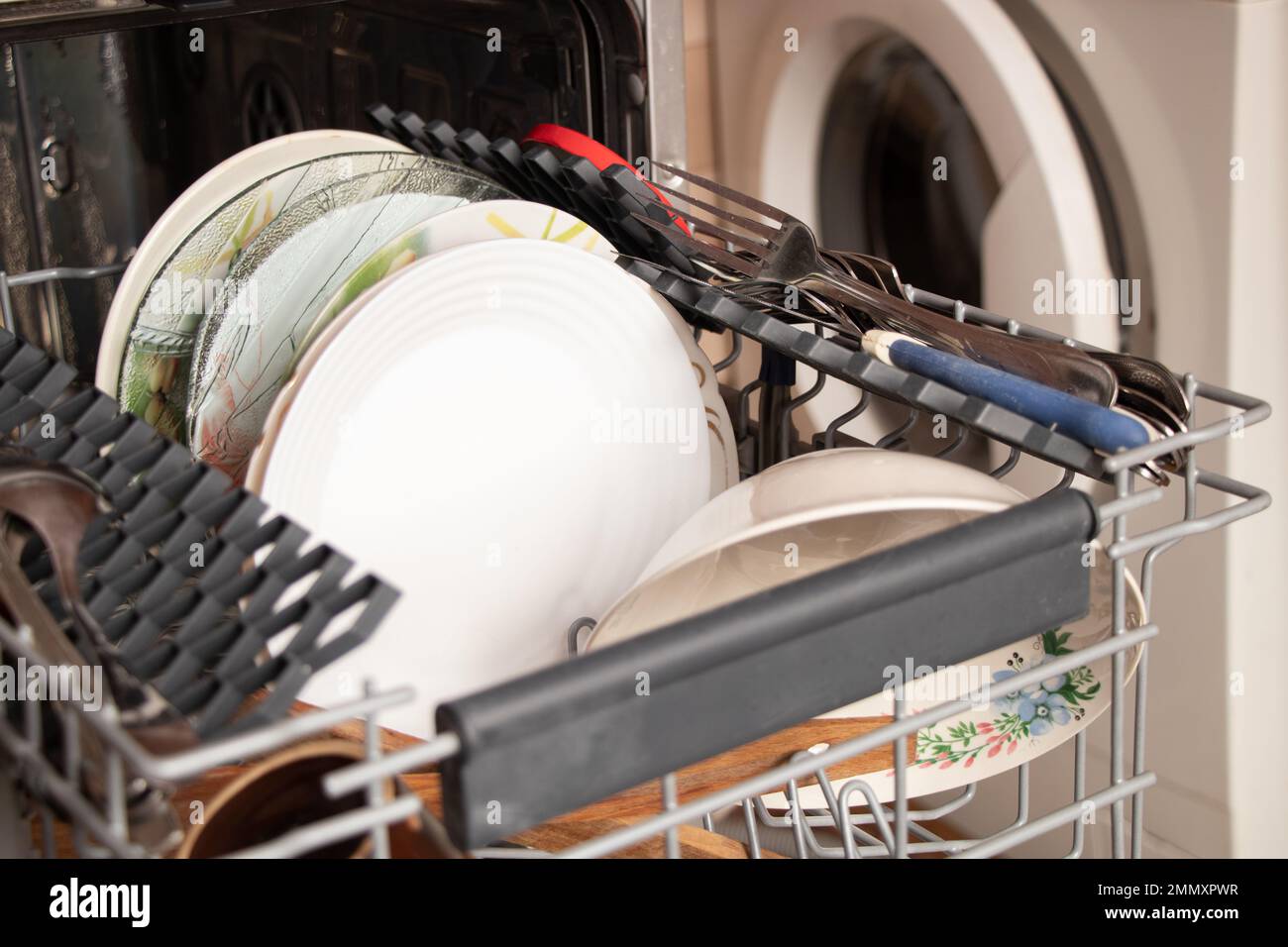 dishwasher with clean dishes at home in the kitchen, washing dishes
