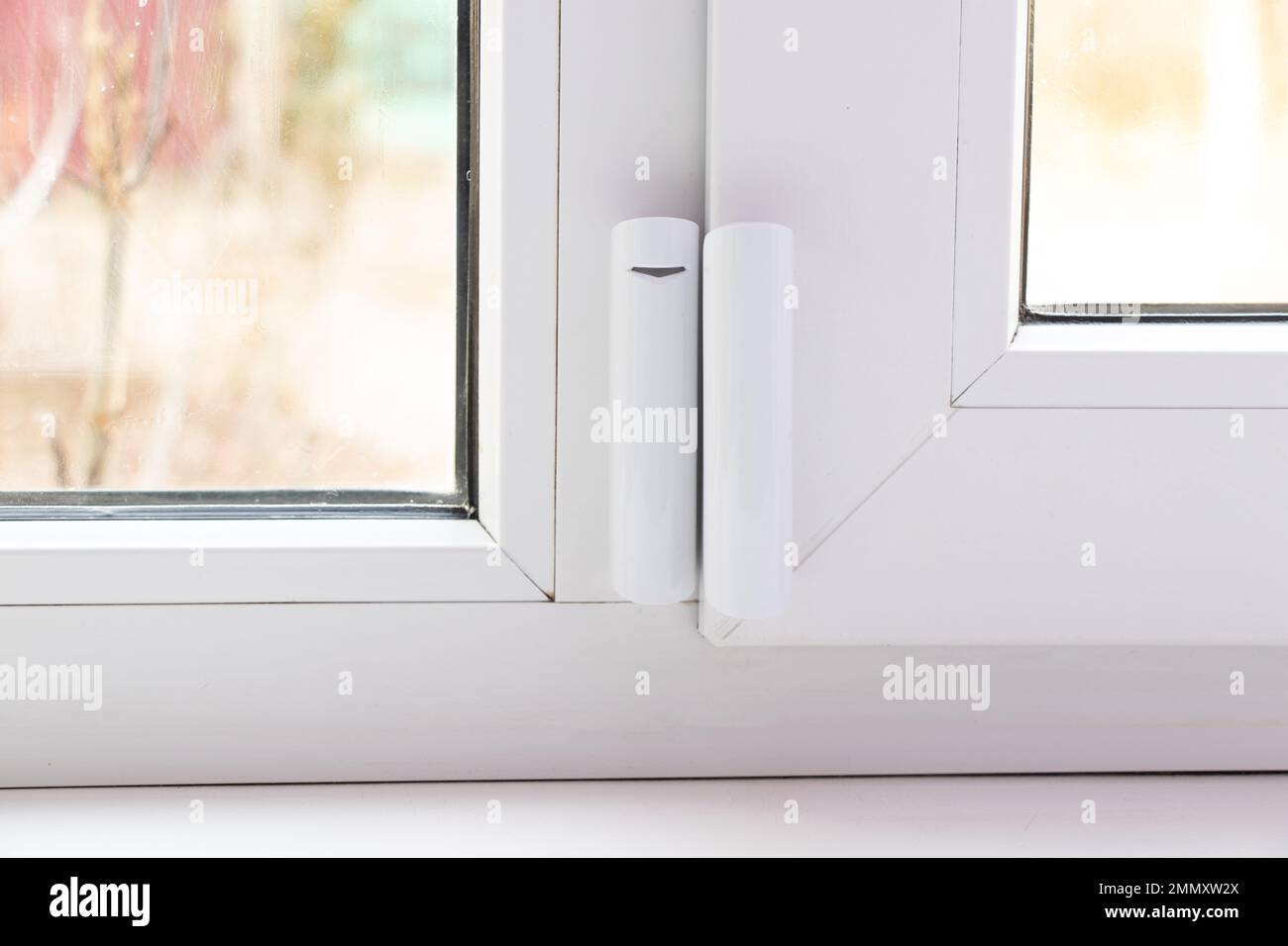 window opening sensor hanging on the window, home alarm system, home protection, home alarm Stock Photo