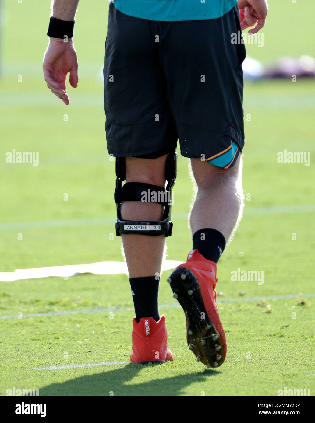 Miami Dolphins quarterback Ryan Tannehill wears a knee brace labeled