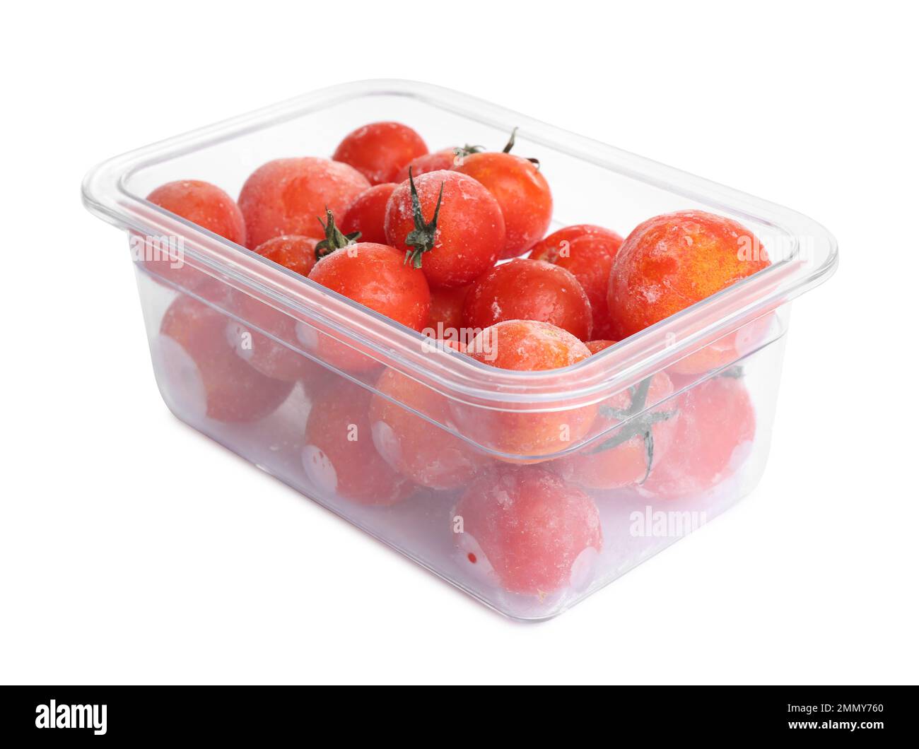 Frozen tomatoes in plastic container isolated on white. Vegetable preservation Stock Photo