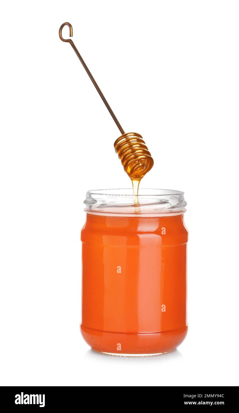 Honey dripping from dipper into jar isolated on white Stock Photo - Alamy