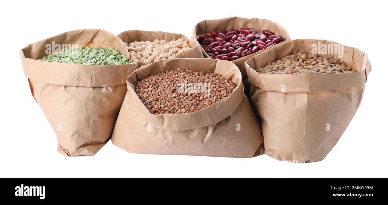 Different types of legumes and cereals in paper bags on white background. Organic grains Stock