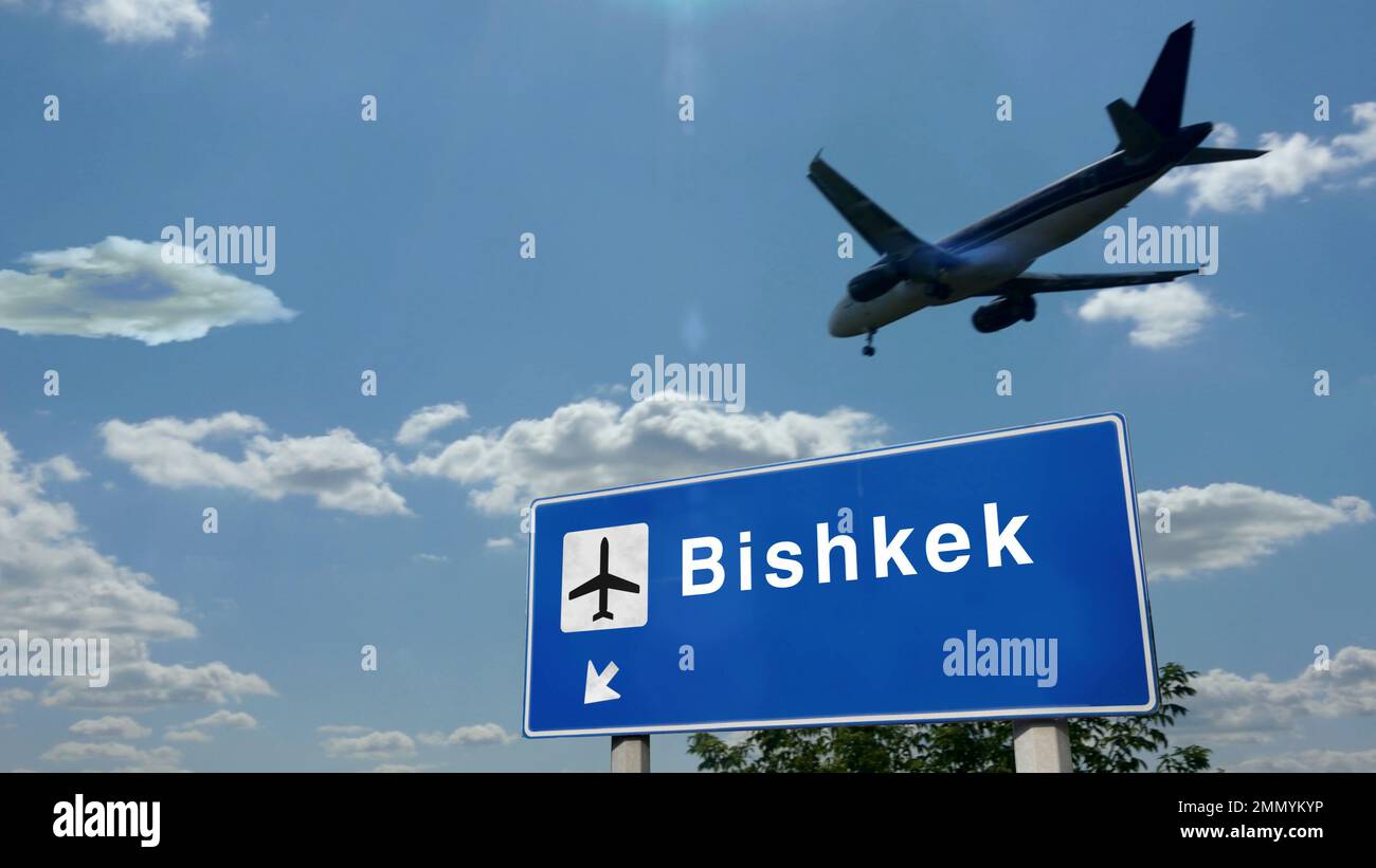Airplane silhouette landing in Bishkek, Kyrgyzstan. City arrival with international airport direction signboard and blue sky. Travel, trip and transpo Stock Photo