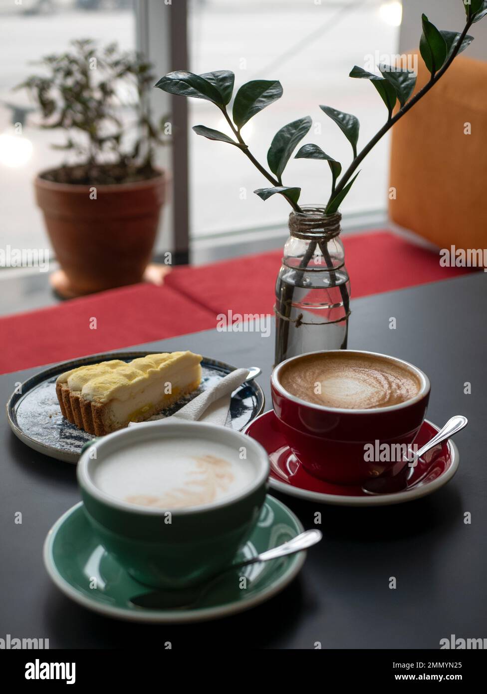 Cappuccino and latte with a foam on the top in ceramic cups for couple or friends, selective focus. Coffee morning in the cafe Stock Photo