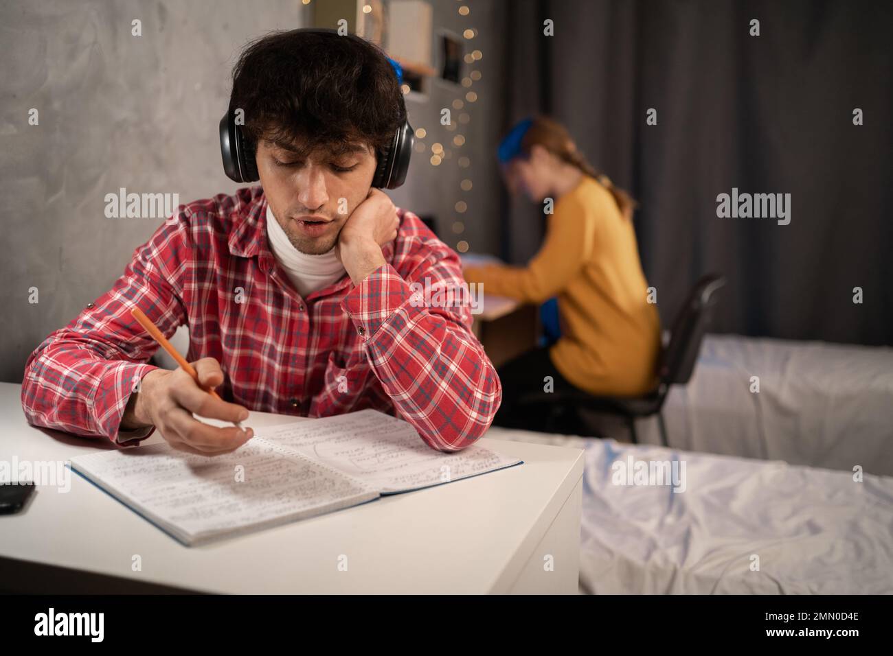 Students studying in dormitory in the evening. Stock Photo