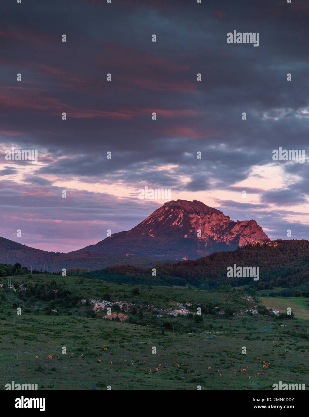 France, Aude, Rennes le Chateau, Mont Bugarach, mountain lit by the last rays of the sun under a cloudy sky Stock Photo