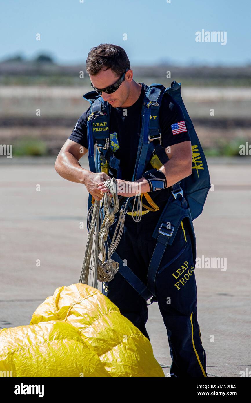 A member of the U.S. Navy Parachute Team, nicknamed the Leap Frogs, gathers his parachute after landing at the 2022 Marine Corps Air Station Miramar Air Show at MCAS Miramar, California, Sept. 24, 2022. The Leap Frogs Navy Parachute Team is made up of active-duty Navy SEALs, Special Warfare Combatant-craft Crewmen and support personnel. The theme for the 2022 MCAS Miramar Air Show, “Marines Fight, Evolve and Win,” reflects the Marine Corps’ ongoing modernization efforts to prepare for future conflicts. Stock Photo