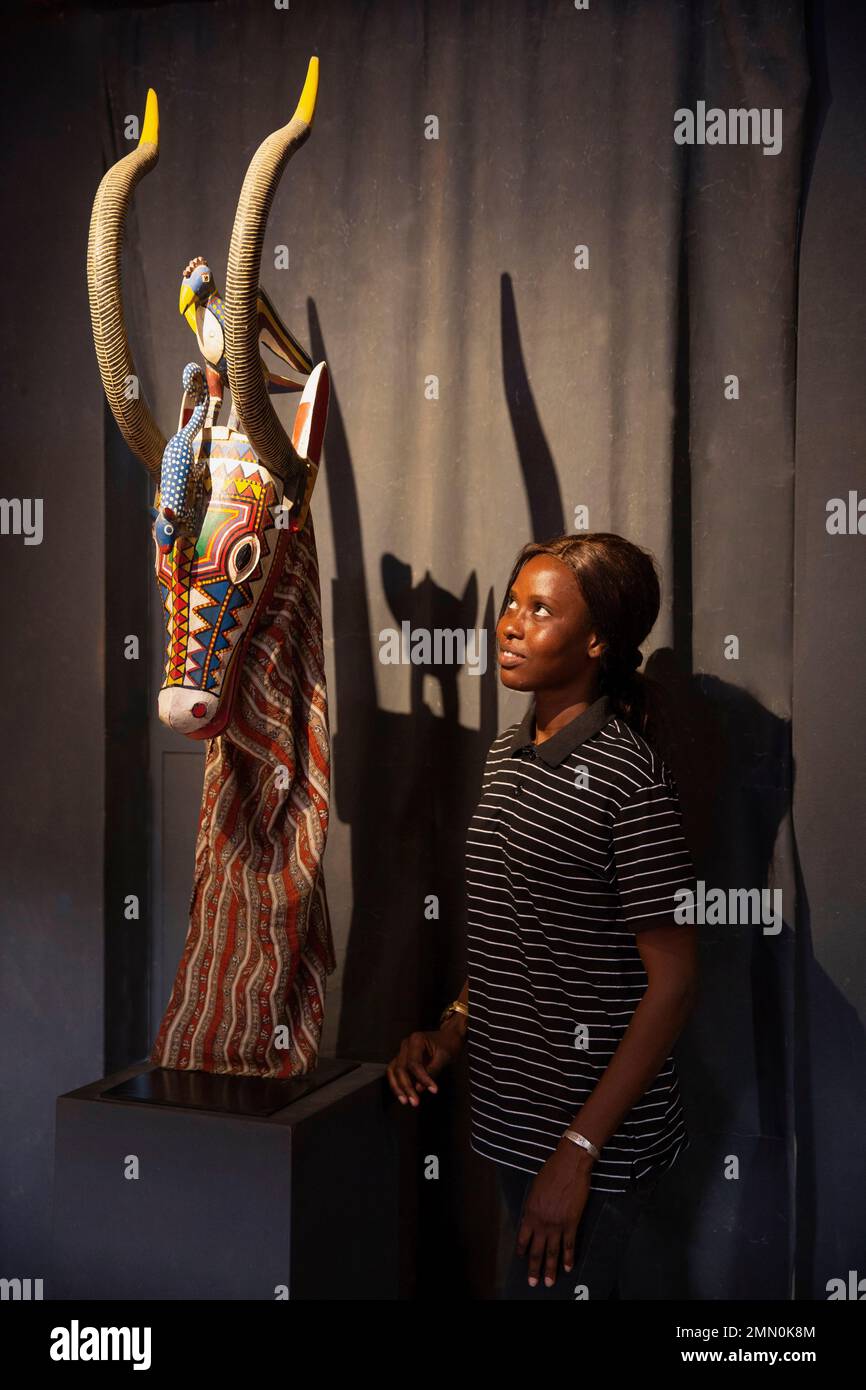 Senegal, Saloum delta listed as World Heritage by UNESCO, Djilor Djidiack, woman looking at a ceremonial antelope mask exhibited at the Mahicao museum, the museum of art and history of West African cultures Stock Photo