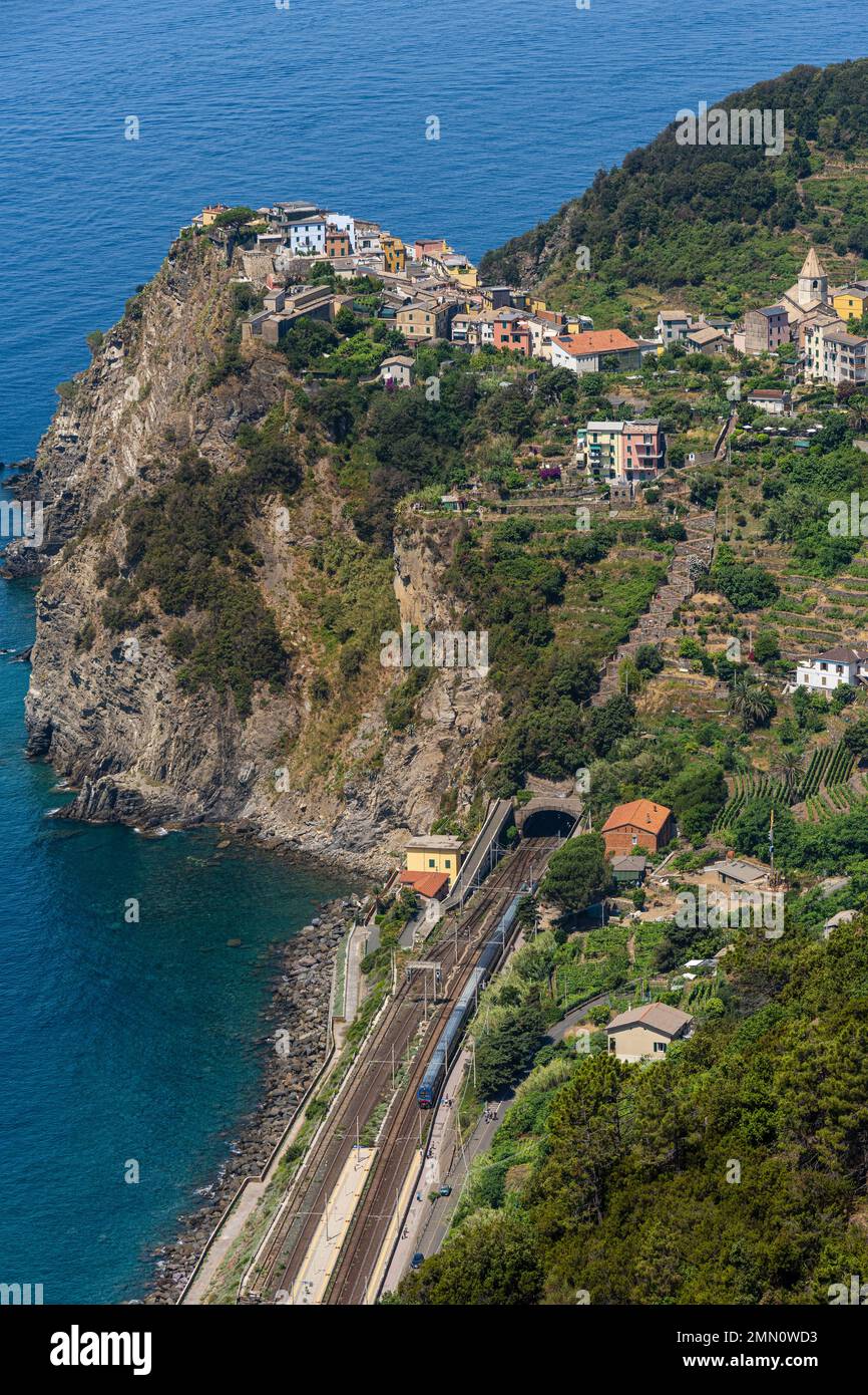 Italy, Liguria, Cinque Terre National Park listed as World Heritage by UNESCO, the village of Corniglia located at the top of a promontory overlooking the Mediterranean Sea at an altitude of about 100 m and its train station accessible by stairs Stock Photo