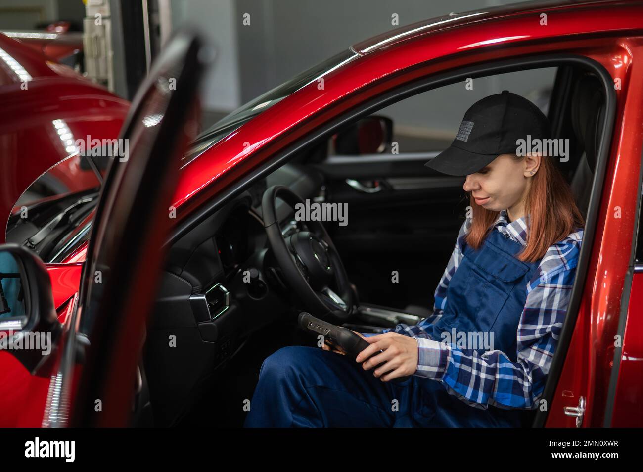 Caucasian female auto mechanic uses hi-res stock photography and images ...