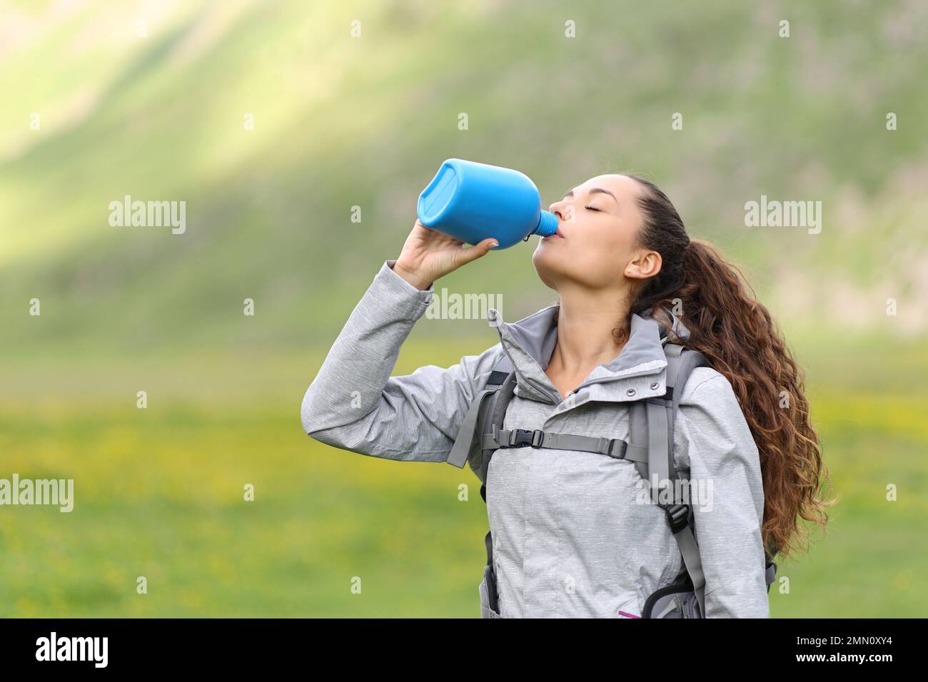 Hiker drinking from canteen in nature Stock Photo Alamy