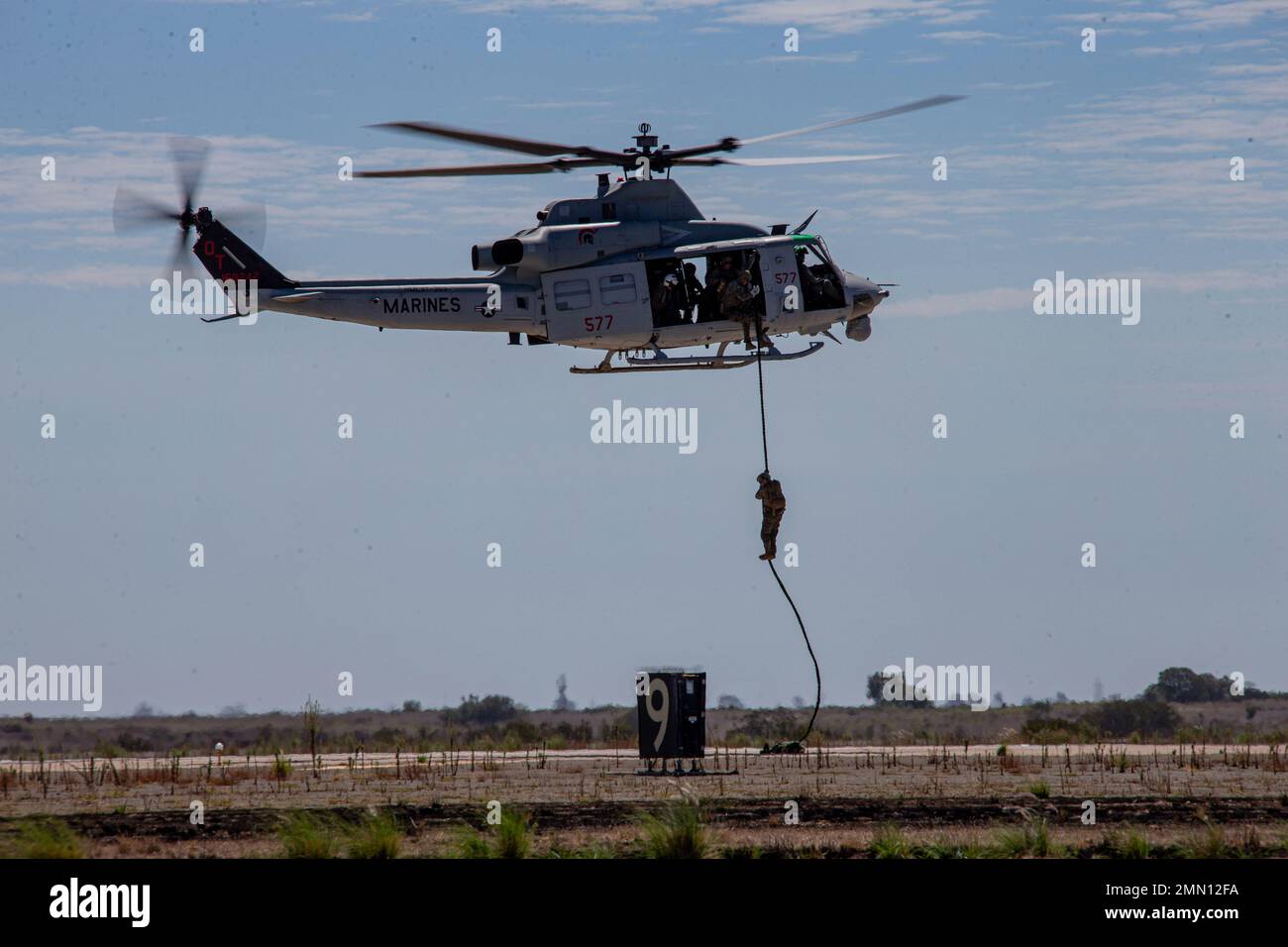 U.S. Marines with 1st Recon Battalion, 1st Marine Division fast rope out of a Bell UH-1Y Venom during the Marine Air-Ground Task Force demonstration of the 2022 Marine Corps Air Station Miramar Air Show at MCAS Miramar, San Diego, California, Sept. 24, 2022. The MAGTF Demo displays the coordinated use of close-air support, artillery and infantry forces, and provides a visual representation of how the Marine Corps operates. The theme for the 2022 MCAS Miramar Air Show, “Marines Fight, Evolve and Win,” reflects the Marine Corps’ ongoing modernization efforts to prepare for future conflicts. Stock Photo