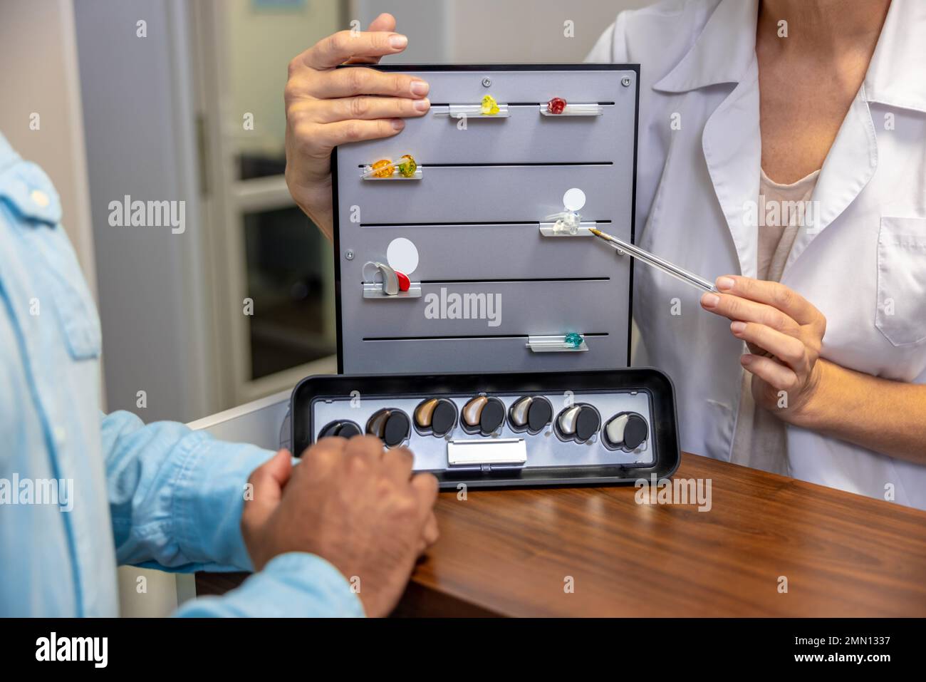 ENT doctor demostrating new hearing aid tools Stock Photo Alamy