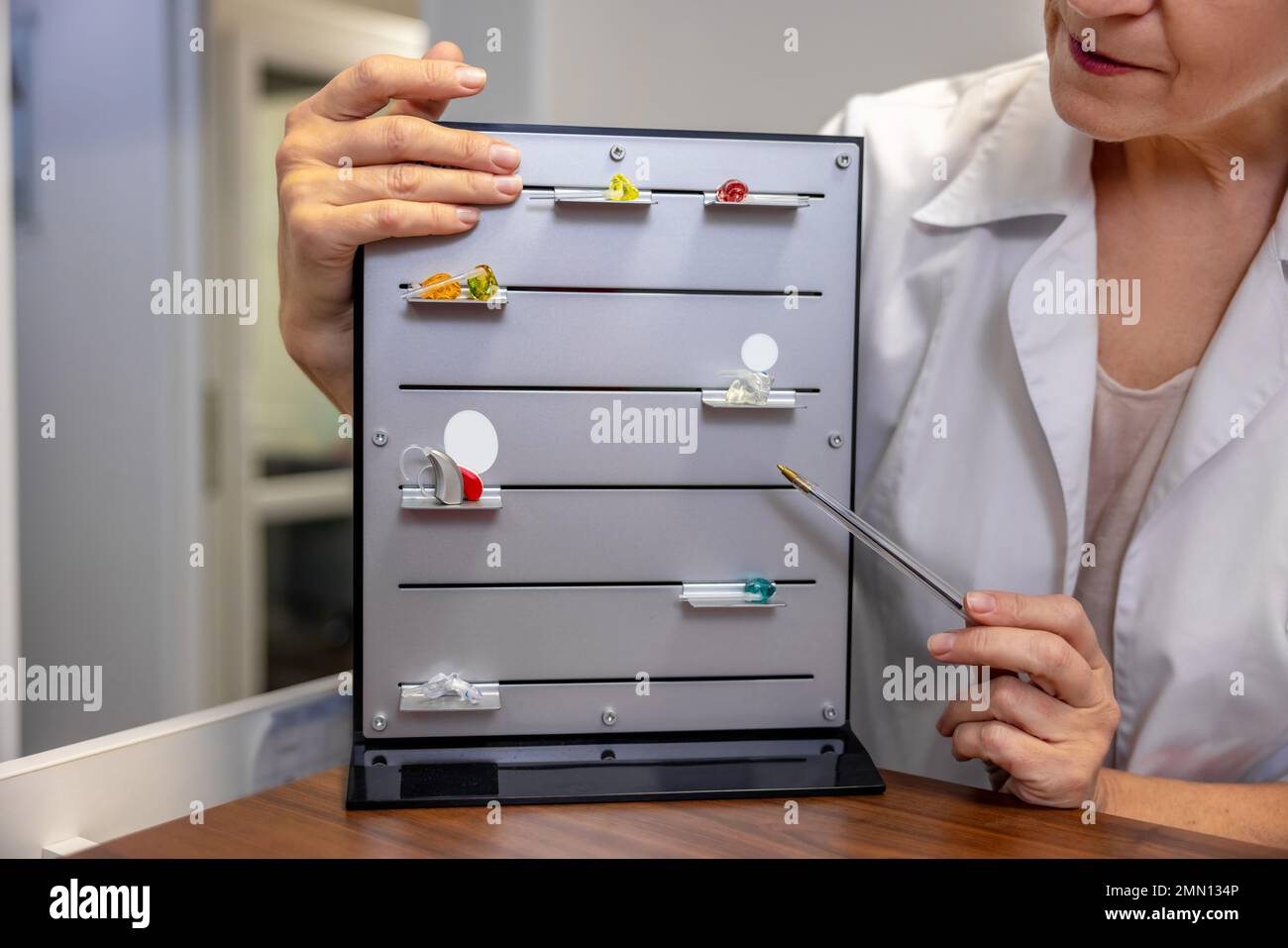 ENT doctor demostrating new hearing aid tools Stock Photo Alamy