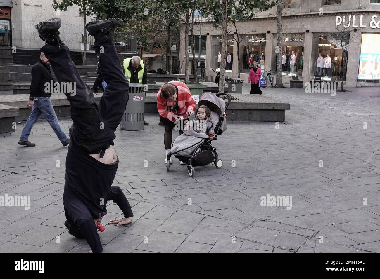 Jerusalem, Israel. 30th Jan, 2023. A self assigned clown tries to cheer up people in downtown Jerusalem while Border Police forces with reinforcements from the IDF Givati Brigade in purple berets, on heightened security, patrol the streets amid an escalation of violence following two terrorist shootings in the capital. Seven Israelis have been murdered and five injured. Credit: Nir Alon/Alamy Live News Stock Photo