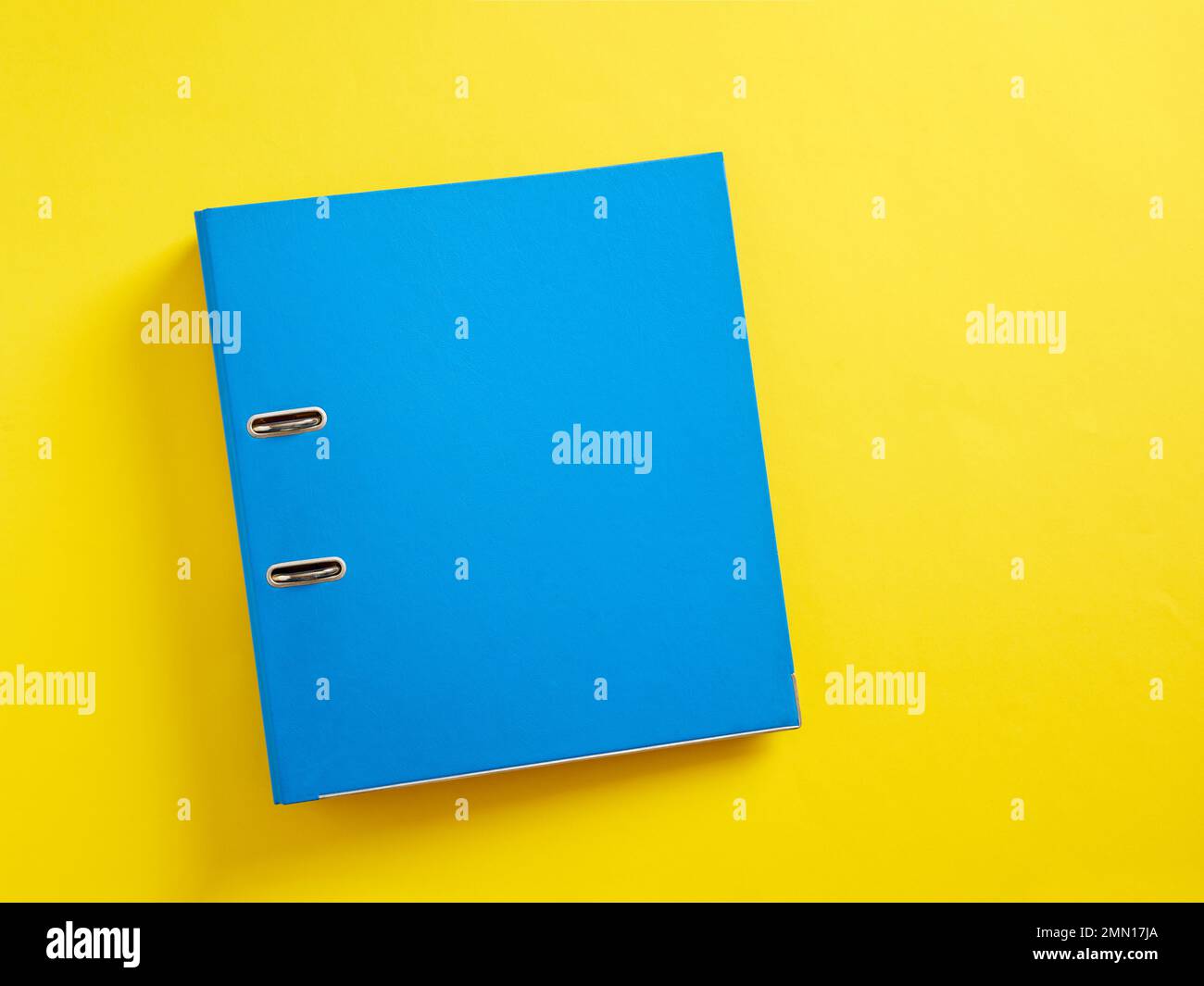 Blue office folder on yellow background. Stock Photo