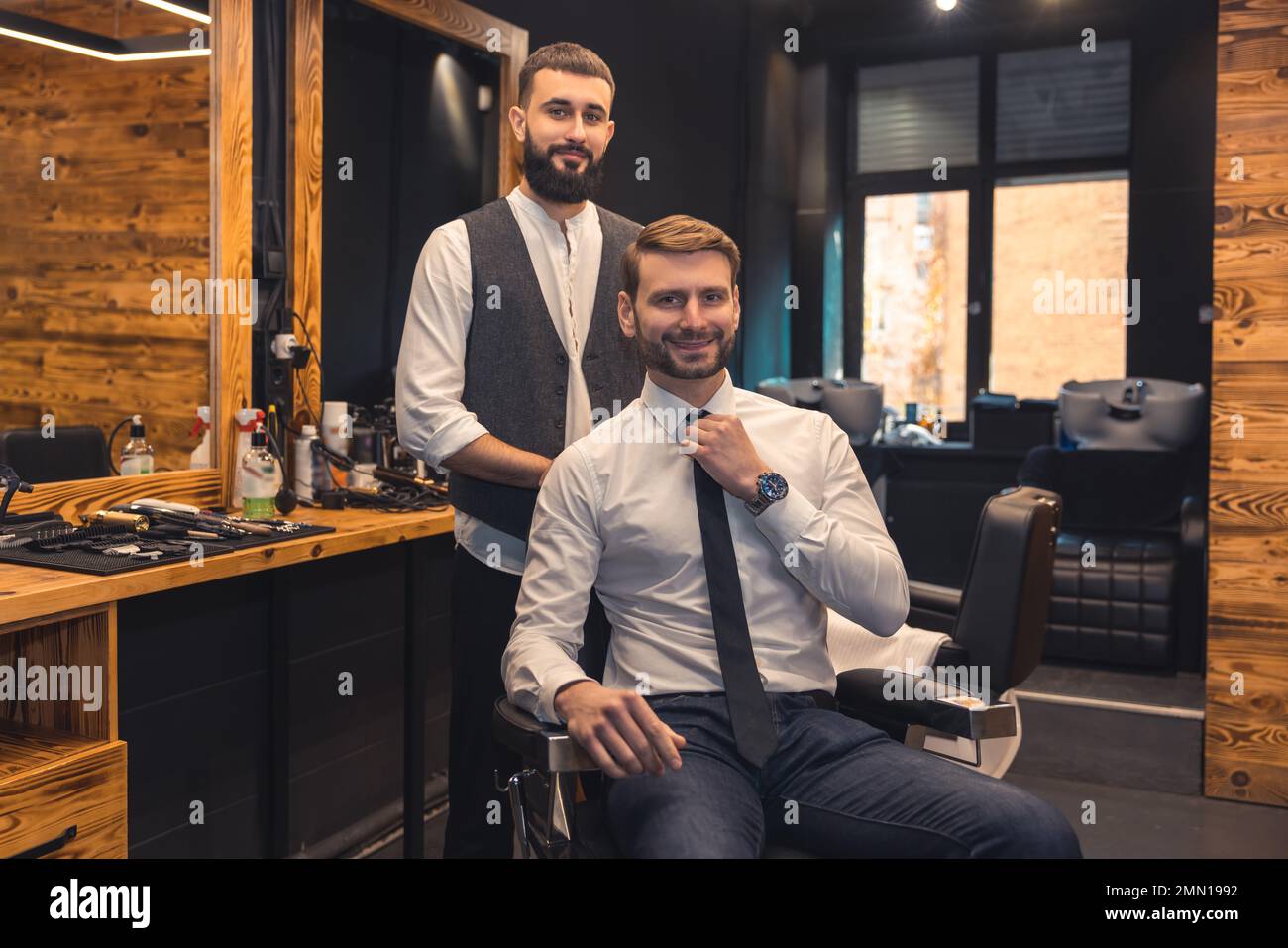 Elegant client sitting in a chiar in the barbershop Stock Photo