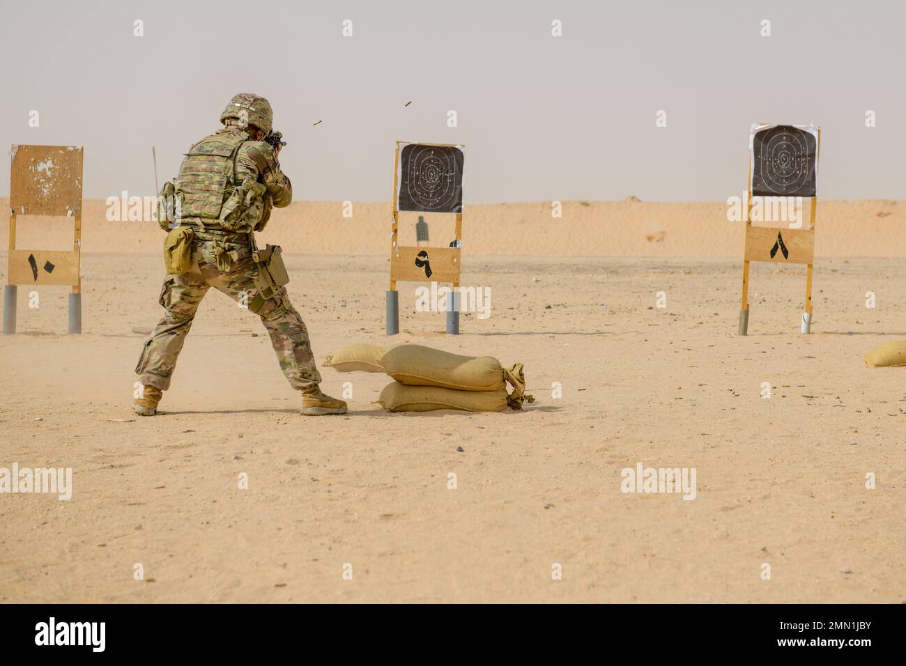 A U.S. Soldier with Task Force Americal from the 1st Battalion, 182nd Infantry Regiment, trains with an M4 carbine at Prince Sultan Air Base, Kingdom of Saudi Arabia, Sept. 24, 2022. The U.S. Air Force’s 378th Expeditionary Security Forces Squadron facilitate and occasionally conduct Joint Force training with the U.S. Army on PSAB’s firing range. Soldiers and Airmen must undergo routine weapons qualification training to ensure safety and proficiency standards. (U.S. Air Force Staff Sgt. Noah J. Tancer) Stock Photo