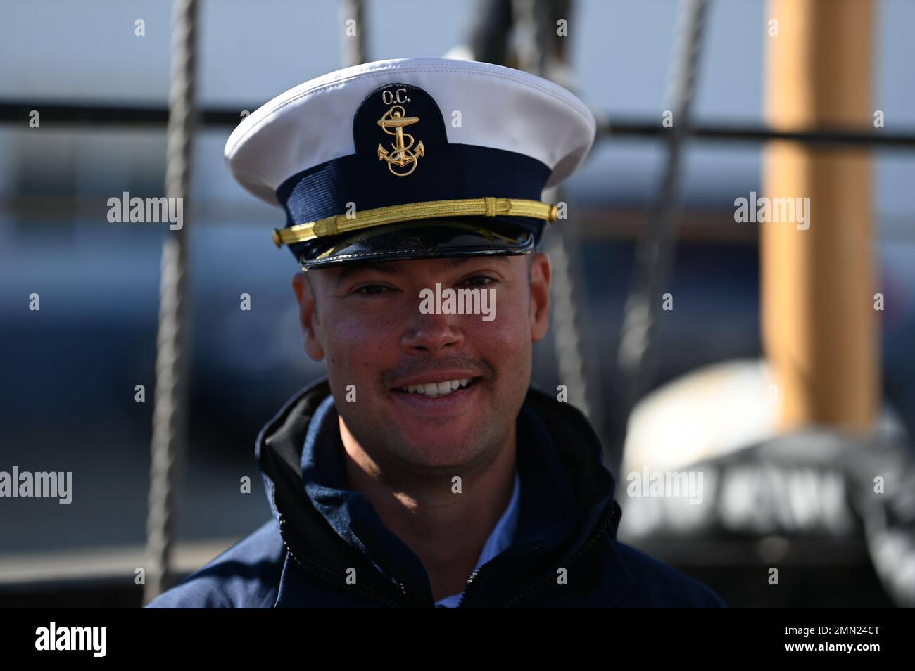 An Officer Candidate Aboard The Coast Guard Cutter Eagle Smiles For A an-officer-candidate-aboard-the-coast-guard-cutter-eagle-smiles-for-a