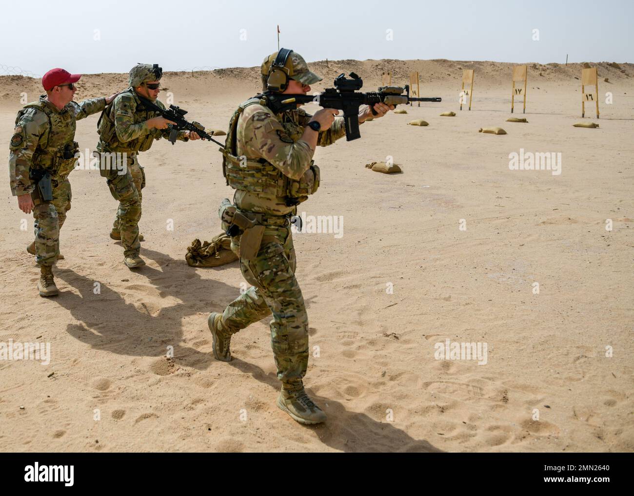 U.S. Air Force Senior Airman Richard York, a fireteam member assigned to 378th Expeditionary Security Force Squadron, provides cover fire for a U.S. Soldier with Task Force Americal from the 1st Battalion, 182nd Infantry Regiment, during a Joint Force combat arms training at Prince Sultan Air Base, Kingdom of Saudi Arabia, Sept. 24, 2022. Soldiers and Airmen must undergo routine weapons qualification training to ensure safety and proficiency standards, which they meet together at PSAB. Stock Photo