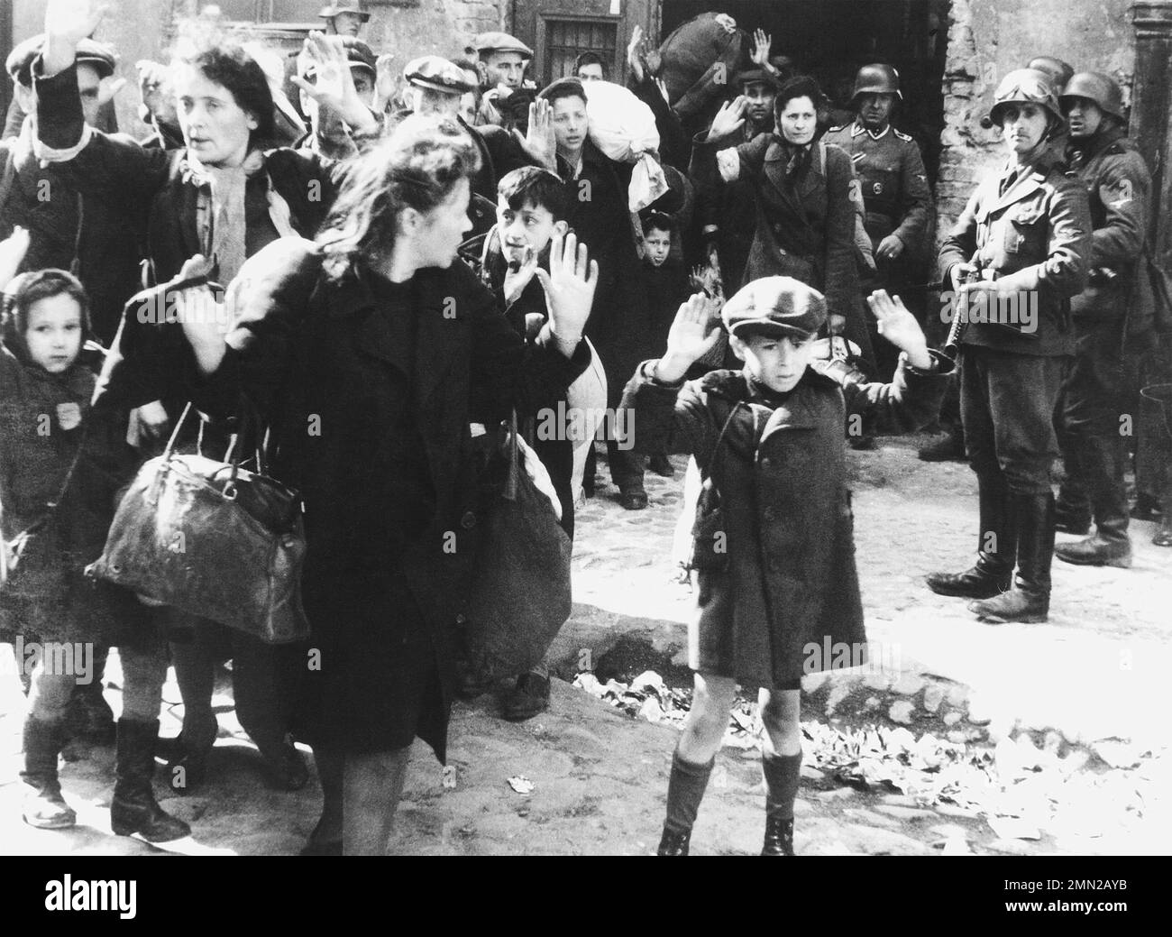 WARSAW GHETTO UPRISING  1943,  At right with submachine gun is SS-Rottenführer Josef Blosche. Others including the boy have not been identified with certainty. Stock Photo
