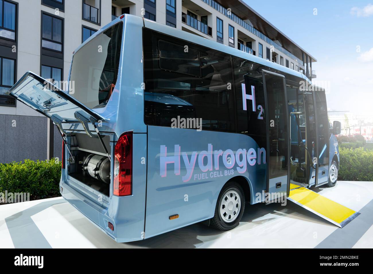 A hydrogen fuel cell bus with an open hood and a hydrogen tank inside