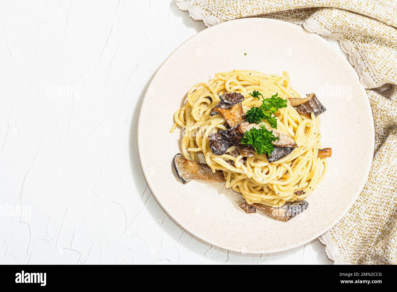 Spaghetti pasta with oyster mushrooms, creamy sauce and parsley