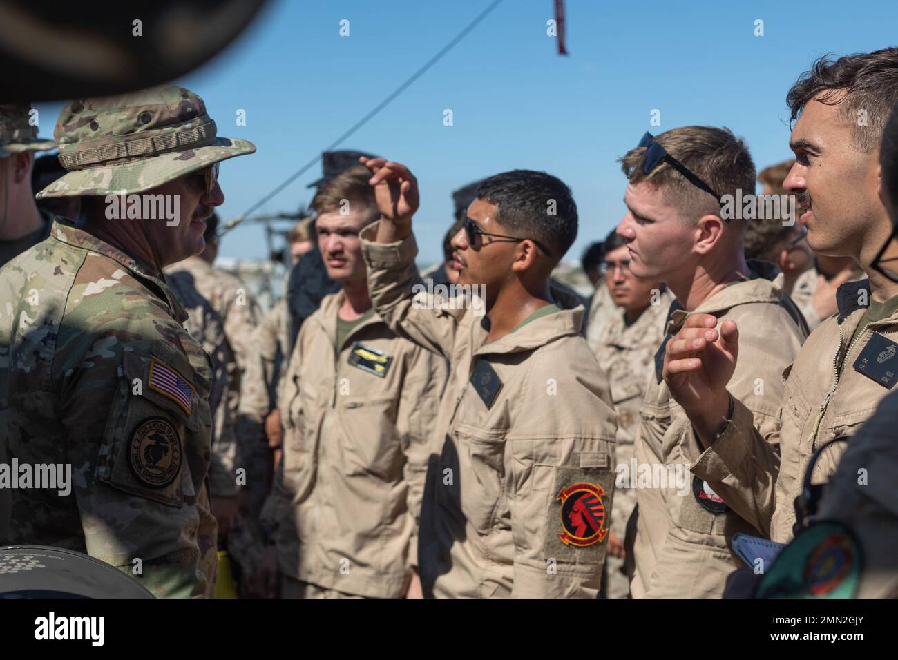 U.S. Army Sgt. Justin Vorhis, Army National Guardsman from Columbia, South Carolina, assigned to 1-151st Attack Reconnaissance Battalion, 59th Aviation Troop Command, South Carolina National Guard, instructs an aircraft familiarization class on a U.S. Army AH-64E Apache, during Weapons and Tactics Instructors (WTI) course 1-23, at Marine Corps Air Station Yuma, Arizona on Sept. 24, 2022. WTI is a seven-week training event hosted by Marine Aviation Weapons and Tactics Squadron One, providing standardized advanced tactical training and certification of unit instructor qualifications to support M Stock Photo