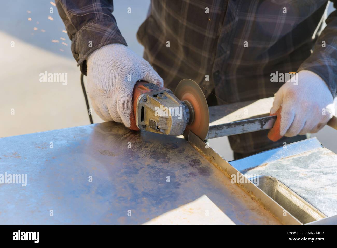Worker using grinder, for cuts metal with grinder Stock Photo