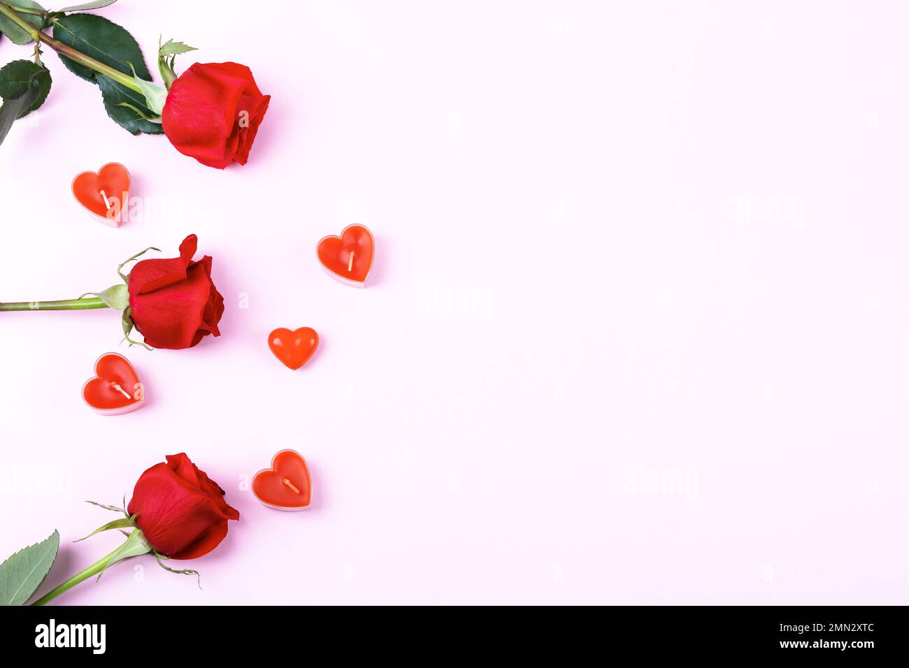 Romantic background with space for text. Red roses and candles in the ...