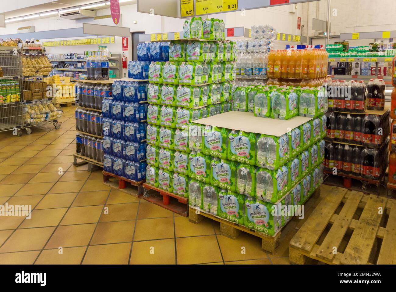 Fossano, Italy - January 28, 2023: pet bottles water and soft drinks on pallet in Italian INS discount store, INS is Italian supermarket chain of PAM Stock Photo