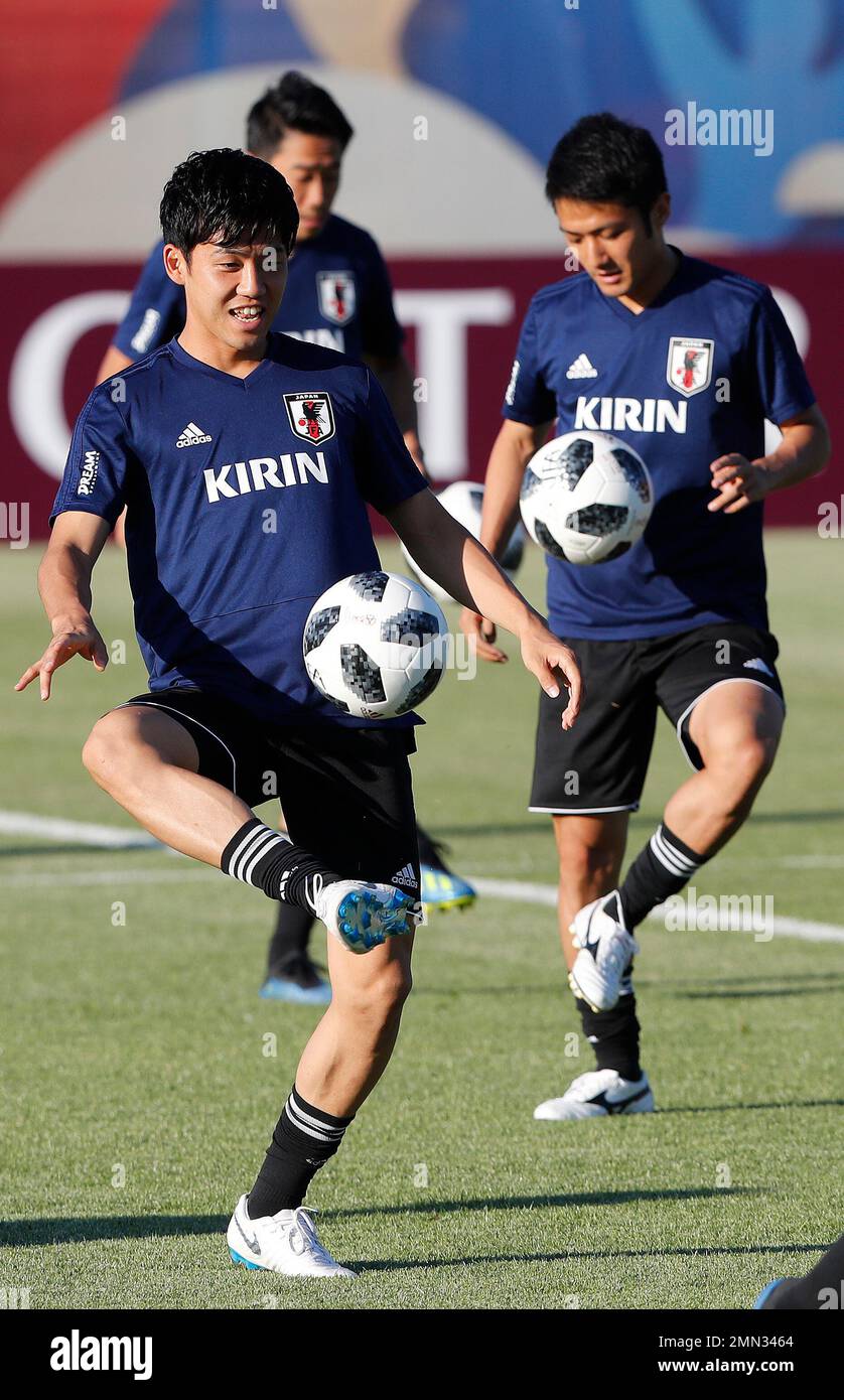 Japan's Wataru Endo, left, kicks the ball during a training session of Japan at the 2018 soccer World Cup in Kazan, Russia, Friday, June 29, 2018. (AP Photo/Frank Augstein) Stock Photo